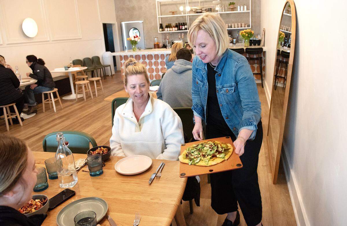 Owner Jamie Butler serves flat bread to Carrie Cogdill, middle, and her daughter Katie Mensonides at Relish eatery on Main Street in Escalon, Calif., Tuesday, March 21, 2023.