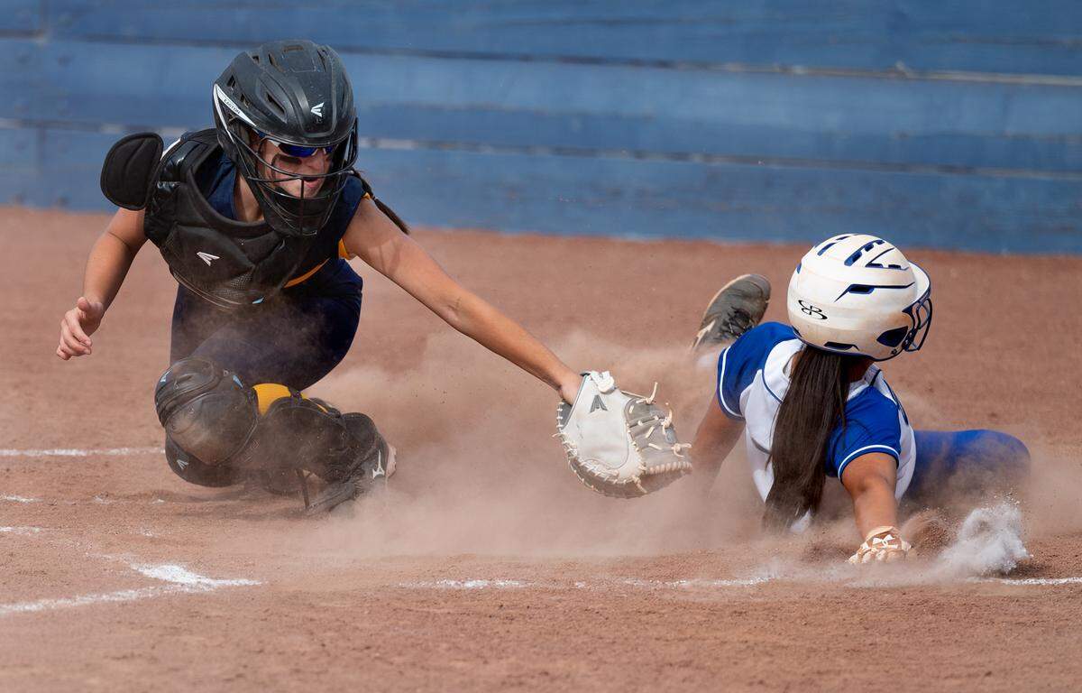 Los Altos runner Lauren Han slides past the tag of Big Valley catcher Emily Avila during the CIF NorCal Softball Championship game at Big Valley Christian High School in Modesto, Calif., on Saturday, June 4, 2022.
