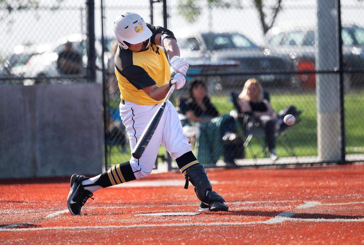 Hughson’s Carlos Guizar hits a single during the Trans Valley League game with Ripon at Mistlin Park in Ripon, Calif., on Wednesday, April 27, 2022. Ripon won the game 11-1.