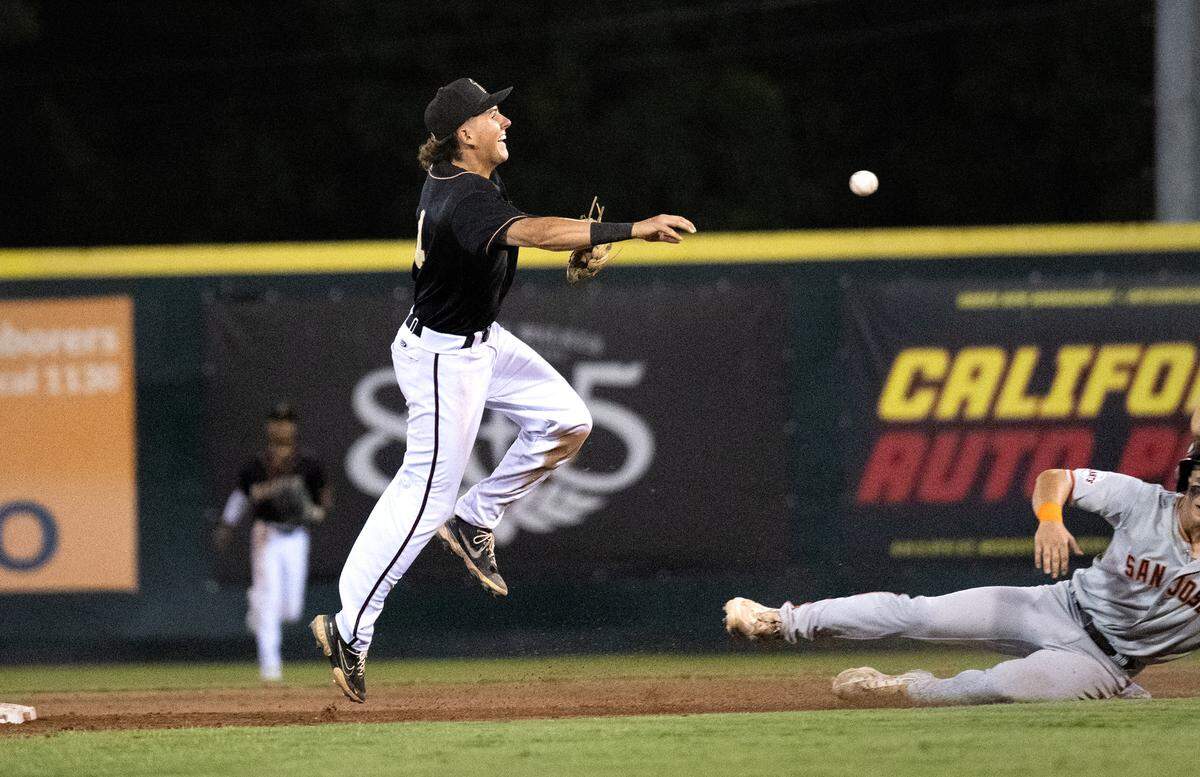 Modesto Nuts shortstop Carter Dorighi turns a double play during the California League North Division series game with the San Jose Giants at John Thurman Field in Modesto, Calif., Thursday, Sept. 12, 2024.