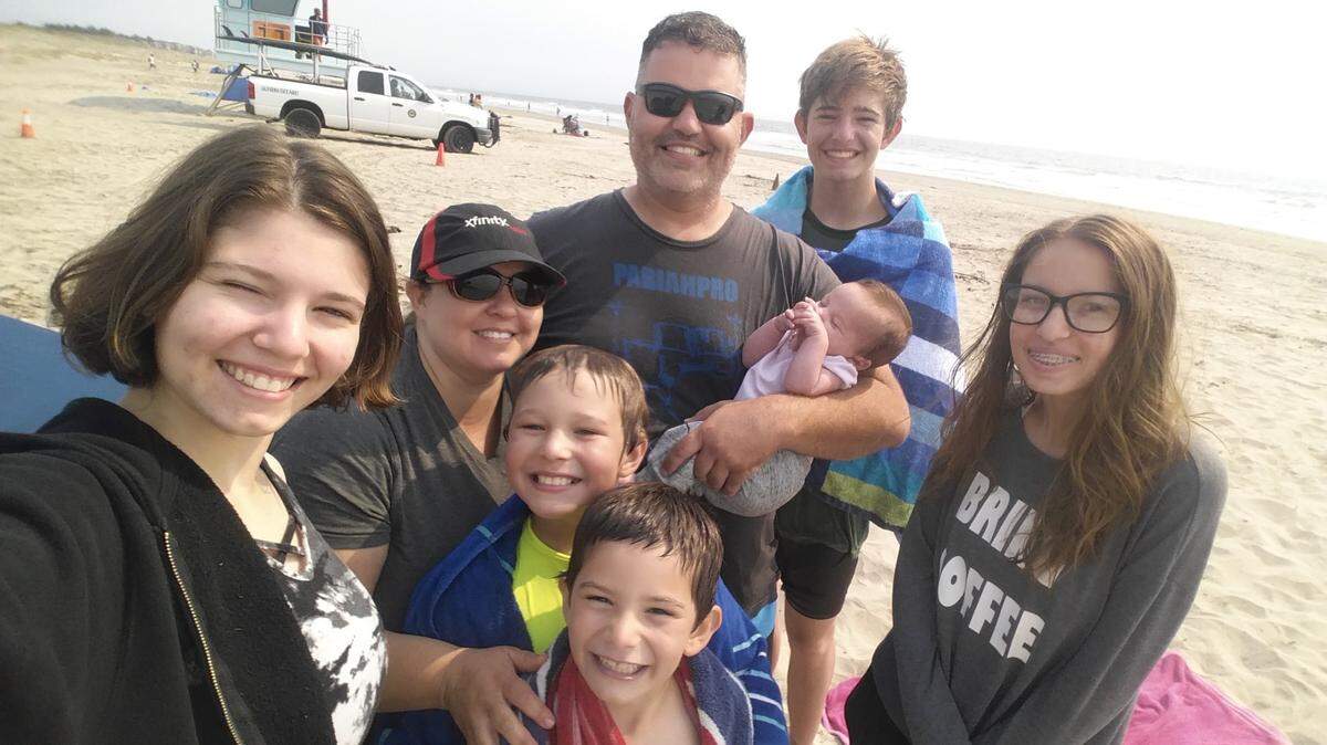 The Holbert family poses for a picture on August 17, 2020, in Watsonville, Calif. The family found out their home along Del Puerto Canyon Road burned the next day in the SCU Lightning Complex fires.