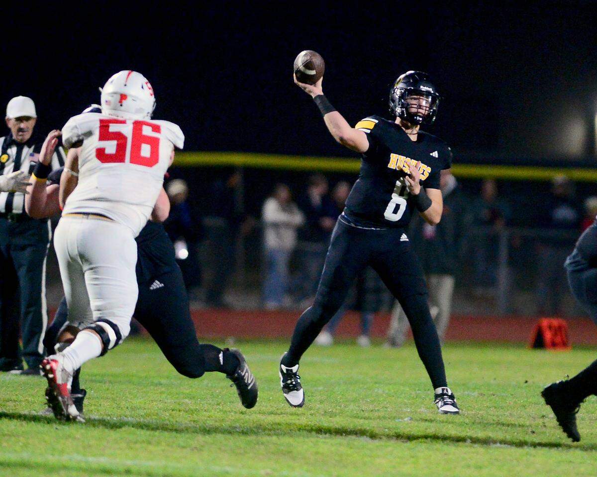 Hughson quarterback Robert McDaniel (8) throws a pass to the flat during a 2023 CIF Division 4-A Northern California Bowl game between Hughson and Palma at Hughson High School in Hughson, Calif. on Saturday, Dec. 2, 2023. Palma won the game 31-21.