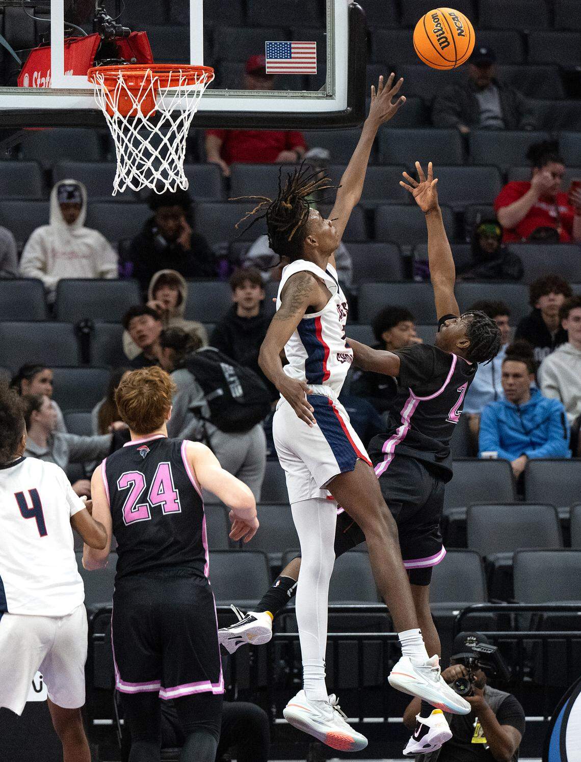Lincoln’s Donez Lindsey lifts the ball over the defense from Modesto Christian’s Devon Johnson in the Sac-Joaquin Section Division I championship game at the Golden 1 Center in Sacramento, Calif., Wednesday, Feb. 21, 2024.