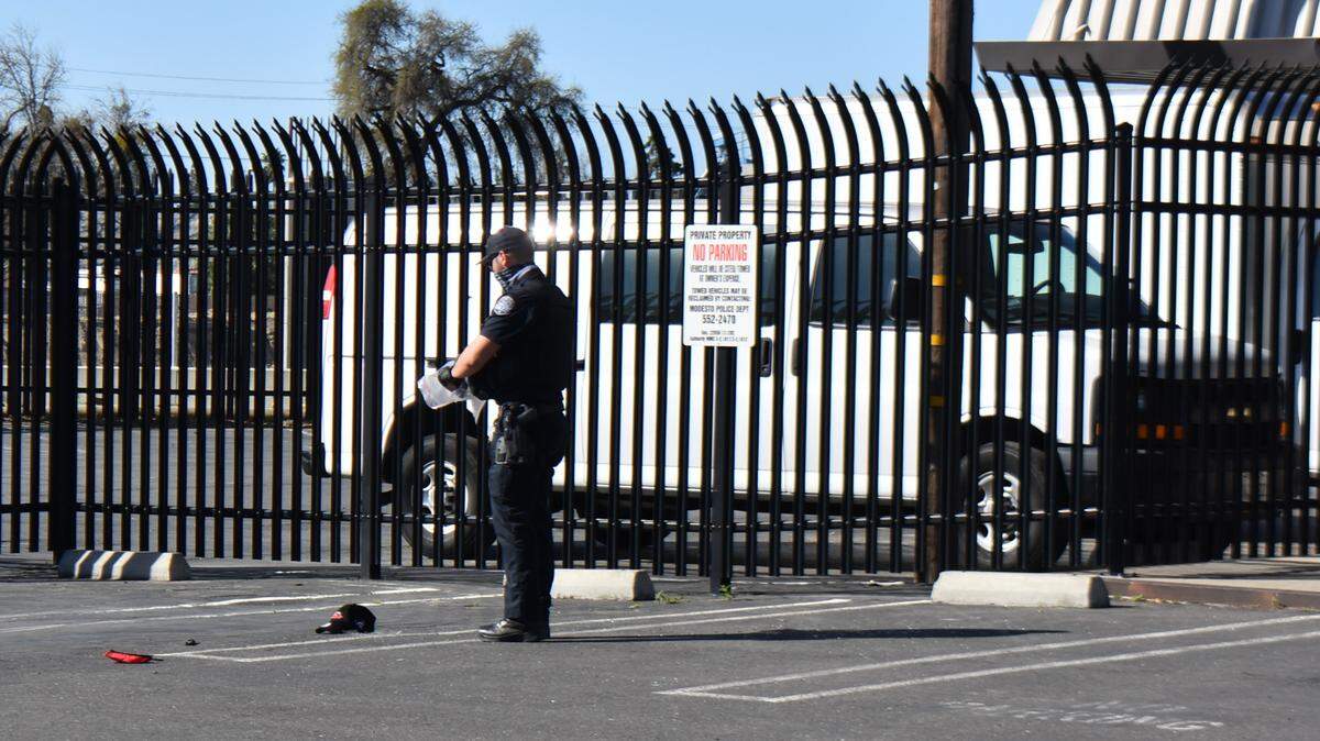 Evidence is gathered after a possible shooting in the parking lot of the Stanislaus County Office of Education’s Media Center on Kansas Avenue in Modesto on Sunday morning, Feb. 28, 2021.