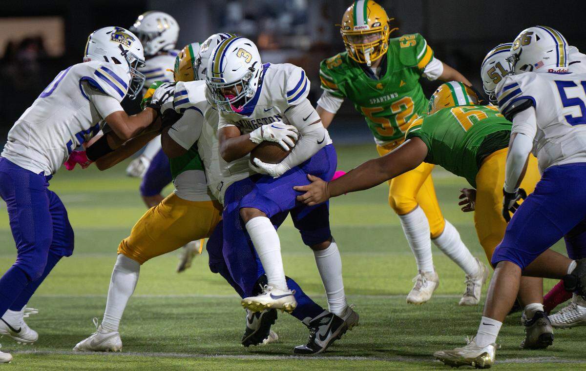 Livingston’s Latrell Tiger (3) slips tackles during the Western Athletic Conference game with Grace Davis at Downey high School in Modesto, Calif., Thursday, Oct. 3, 2024.