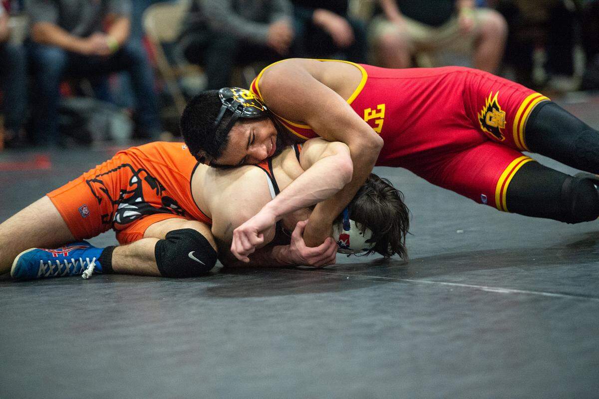 Oakdale’s Jesse Meza and Vacaville’s Casey Roberts wrestle in the 126 lb. match during the D1 Sac-Joaquin Section team duals wrestling championship at Lincoln High School in Stockton, Calif., Saturday, Jan. 28, 2023. Meza pinned Roberts for the win.