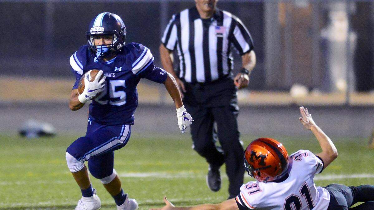 Downey running back Robert Rivera (25) runs past a Merced defender during a game between Downey and Merced in Modesto at Downey High School on August 31, 2017.