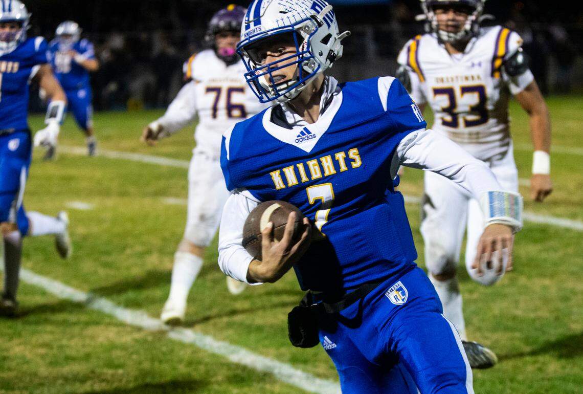 Ripon Christian quarterback Mason Tameling (7) runs the ball upfield towards a first down in the Sac-Joaquin Section Division VII-A Championship against Ripon Christian at Ripon Christian High School on Friday, Nov. 17, 2023.
