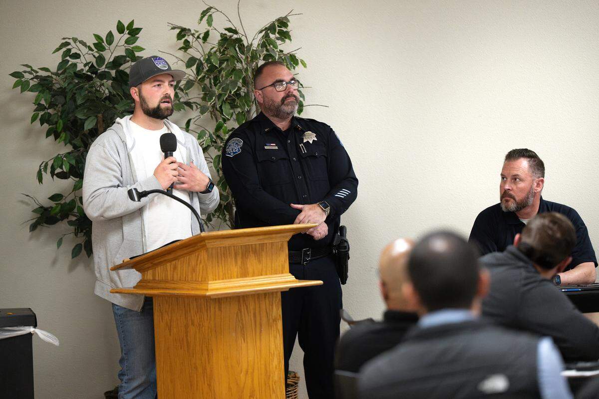 Modesto Police Department Property Crime Unit Detective Jacob Hook speaks about avoiding financial scams during MPD’s South Modesto Community Forum at the King-Kennedy Center in Modesto, Wednesday, May 14, 2025. South Area Commander Lt. Mike Hammond, middle, hosted the forum.