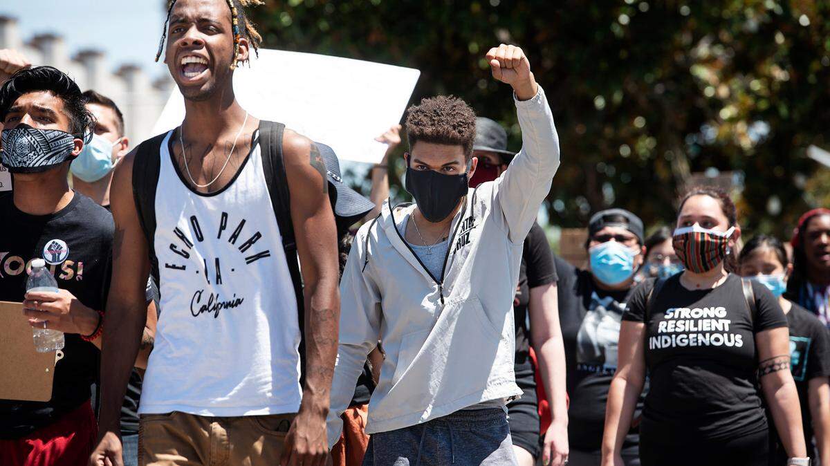 A small group of demonstrators marches down G Street during a Juneteenth march in Modesto, Calif., on Friday, June 19, 2020.