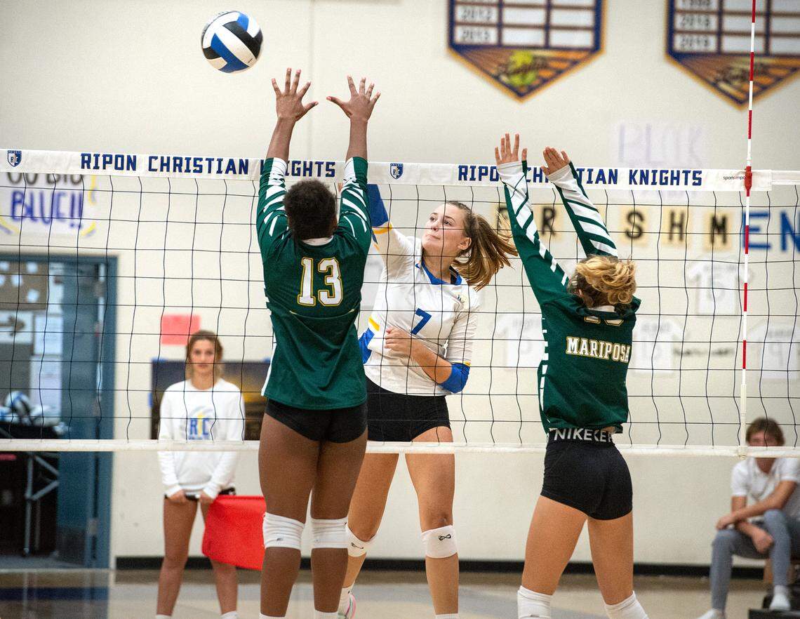 Ripon Christian’s Jordan Vander Veen spikes the ball past Mariposa defenders Emelia Williams (13) during the Southern League game in Ripon, Calif., Thursday, Oct. 13, 2022.