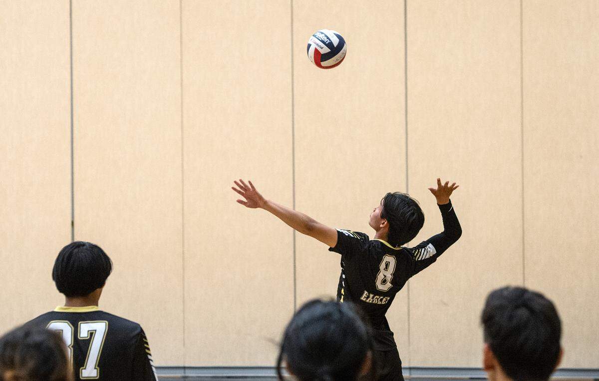 Enochs’ Matthew Suico serves during the Central California Athletic League match with Downey at Enochs High School in Modesto, Calif., Tuesday, April 4, 2023. Enochs won the match 3-1.