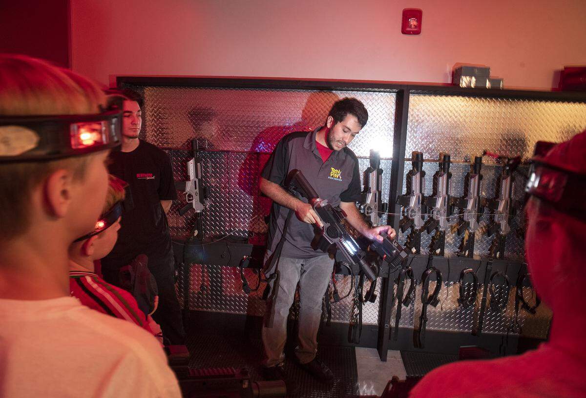 IT tech Josue Irizarry explains how the laser guns work in the new laser tag arena at Ten Pin Fun Center in Turlock, Calif., Thursday, July 25, 2019.