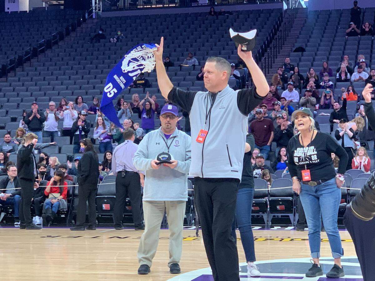 Denair coach RJ Henderson salutes the crowd after the Coyotes’ 62-45 win over Bradshaw Christian in the CIF Sac-Joaquin Section Division V championship at Golden 1 Center on Saturday, Feb. 26, 2022.