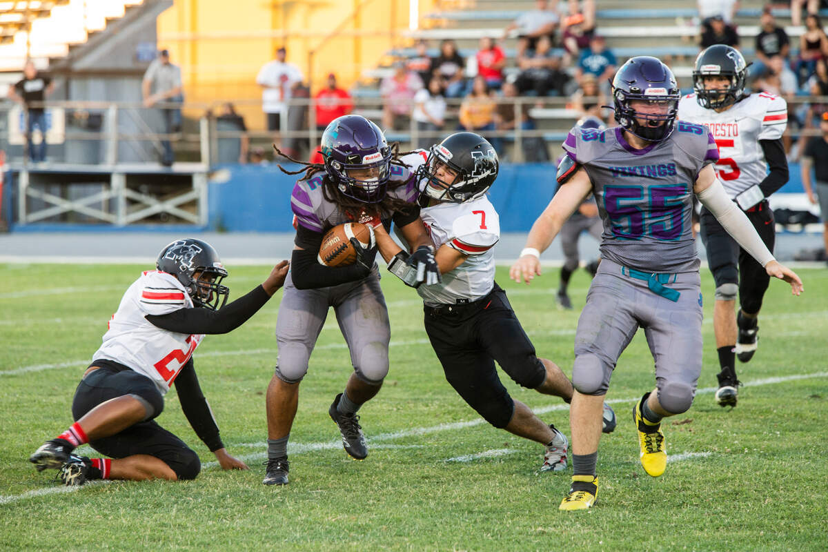 Joseph Montez, 2, of Johansen High works his way through a hole of Modesto Panthers during play Friday August 19, 2022.