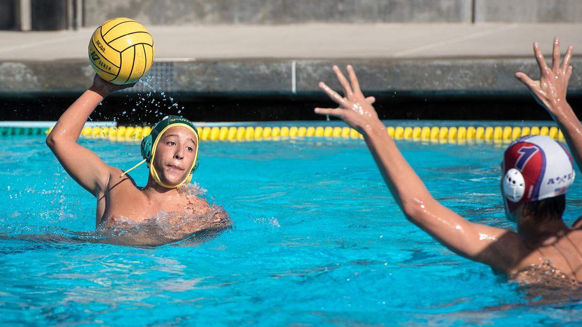 Davis’ Octavio Varela scores past South Eugene Oregon goalie Luka Bogdanov during the DeLong Water Polo Tournament at Enochs High School in Modesto, Ca., on Friday, Oct. 19, 2018. South Eugene Oregon won the game 16-4.