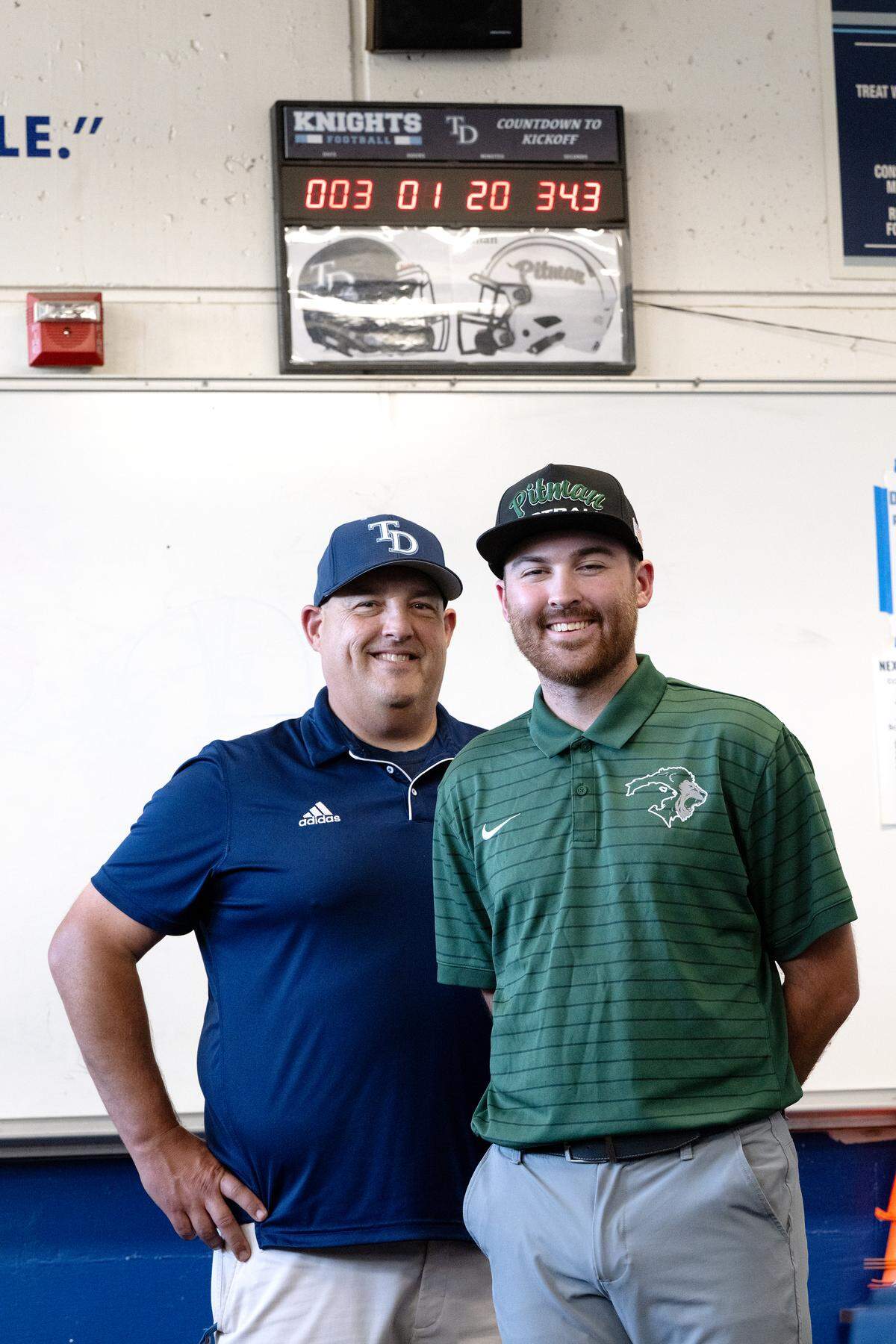 Father and son head coaches Jeremy Plaa (Downey), left, and Braden Plaa (Pitman) at Downey High School in Modesto, Tuesday, Oct. 7, 2025. The coaches are seen here in the DHS locker room with a countdown clock to Friday’s  CCAL game in Turlock.