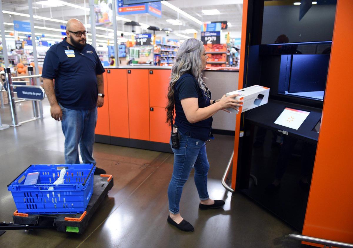 Department manager Amanda Arriaga adds an order to the pickup tower Friday afternoon September 13, 2019 at the McHenry avenue Walmart in Modesto, Calif. Also pictured at left is co-manager Juanito Herrera. New Walmart pickup towers allow guests to retrieve their online orders at fixed locations, instead of home delivery.
