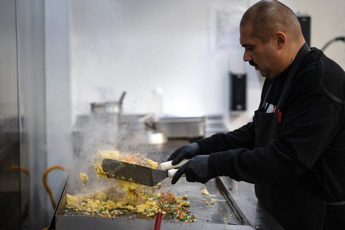 Chef Tomas Suarez prepares fried rice at Mexihanas Hibachi Grill in J Street in Modesto, Calif., Thursday, Dec. 8, 2022.
