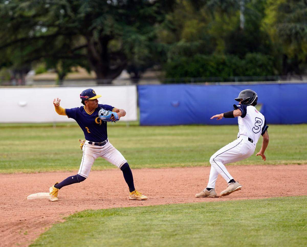 Gregori shortstop Izaia Perez turns a double play in a CCAL game against Downey High at Downey High School in Modesto, Calif. on Wednesday, April 16, 2025.