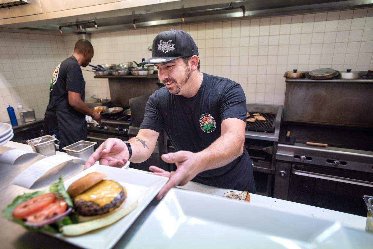 Owner and chef Matt Martin serves up a valley burger at the now-closed Valley Grill on McHenry Avenue in Modesto, Calif., on Tuesday, Oct. 5, 2021.