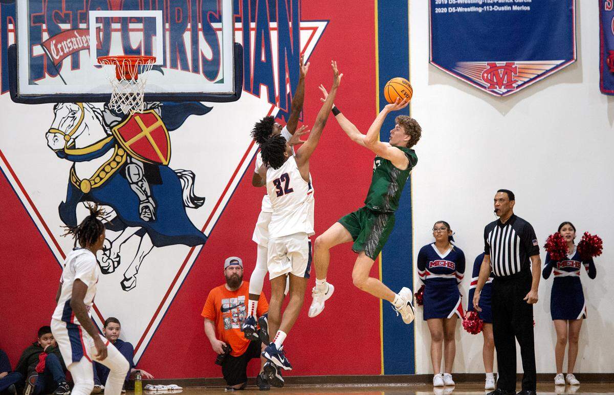De La Salle’s Alec Blair (33) shoots over Modesto Christian’s Jayvn Royal and Jalen Brown during the NorCal Open Division semifinal playoff game in Salida, Calif., Saturday, March 4, 2023.