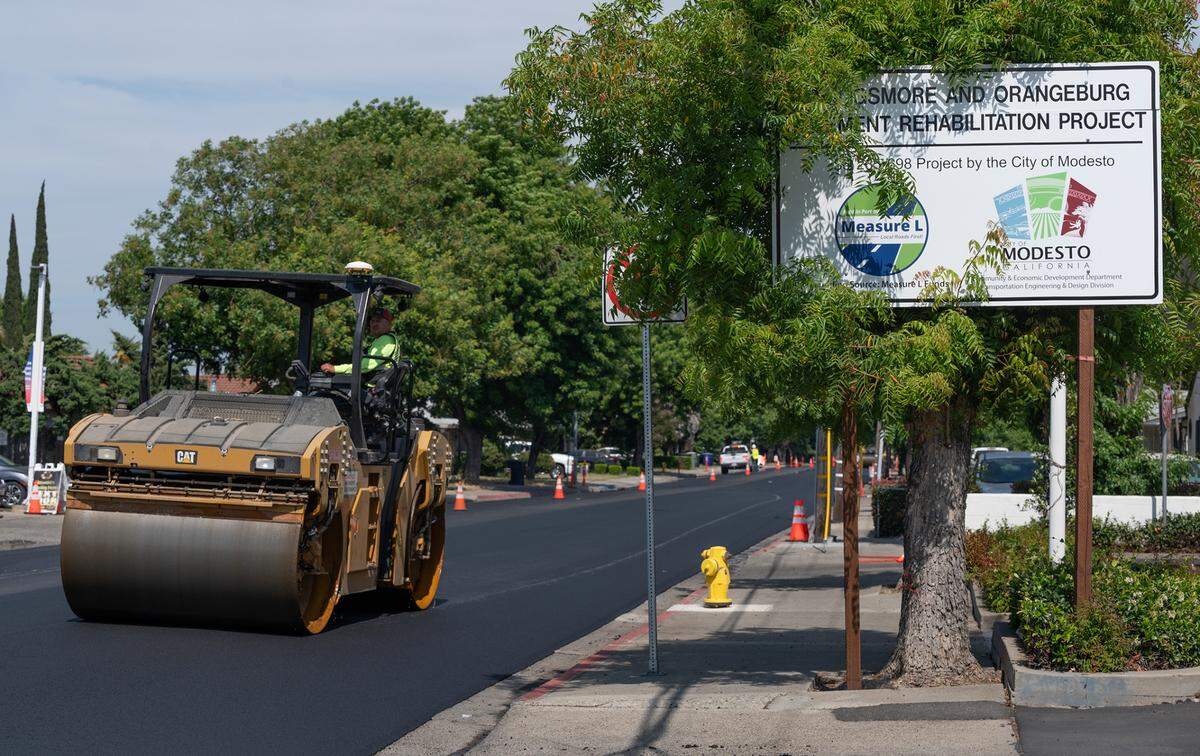 A crew from United Pavement Maintenance Inc. resurfaces Orangeburg Avenue from Coffee Road to Oakdale Road in Modesto, Calif., Thursday, June 22, 2023. The project was funded using Measure L sales tax money.
