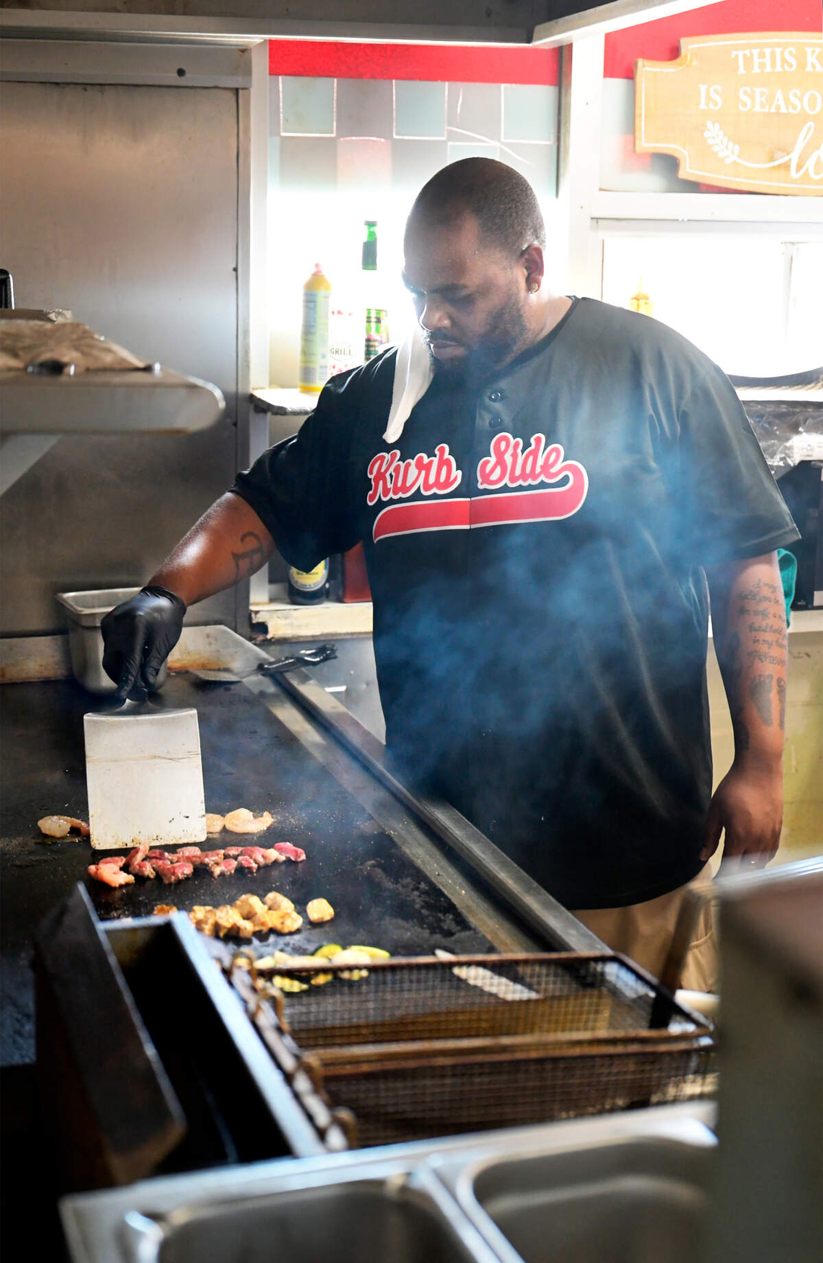 Chef and owner Ed Jackson works the grill at Kurbside Eatery in Denair, Wednesday, July 16, 2025. 