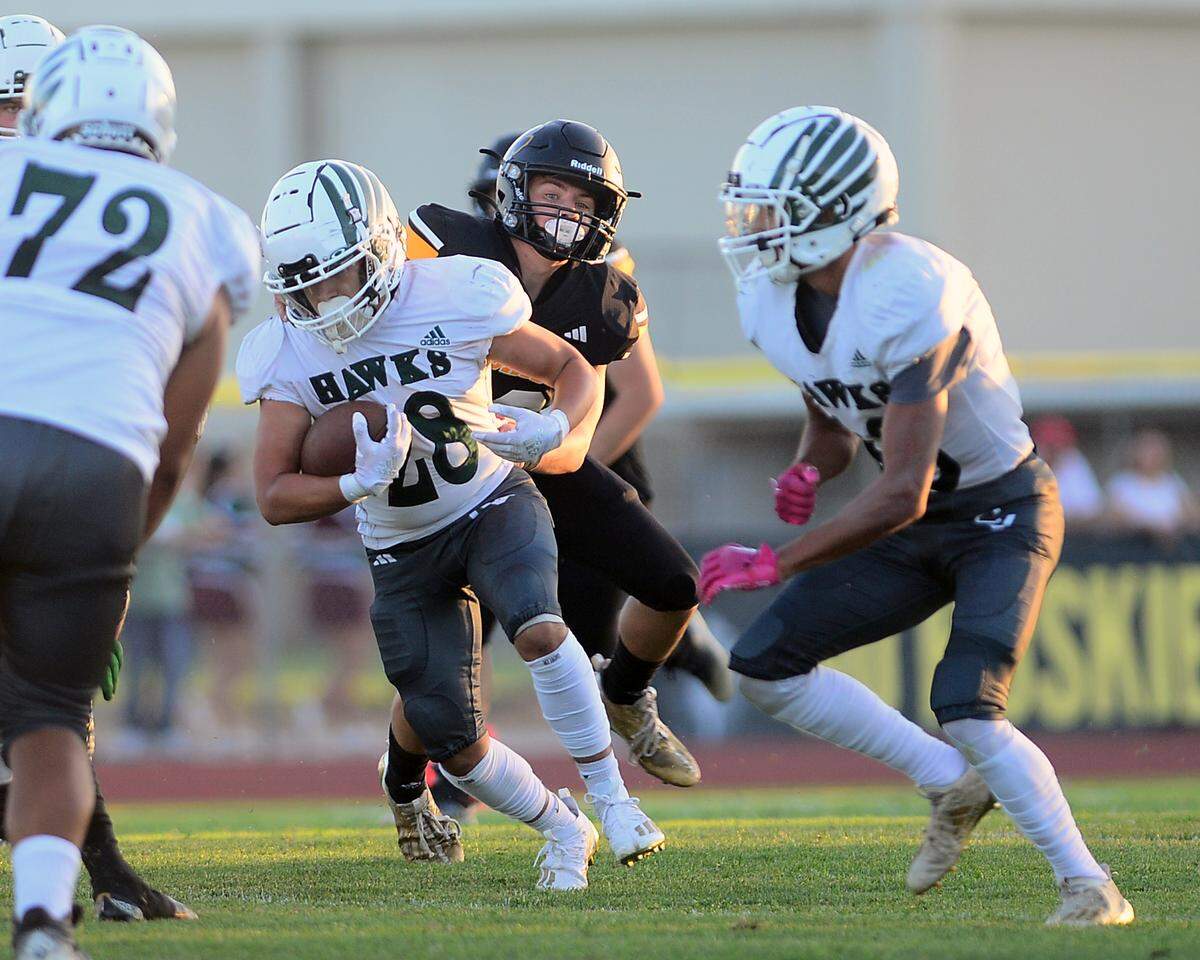 Central Valley running back Tristan Villicana gets tackled by a Hughson defender during a game between Hughson High School and Central Valley High School at Hughson High School in Hughson California on August 25, 2023.