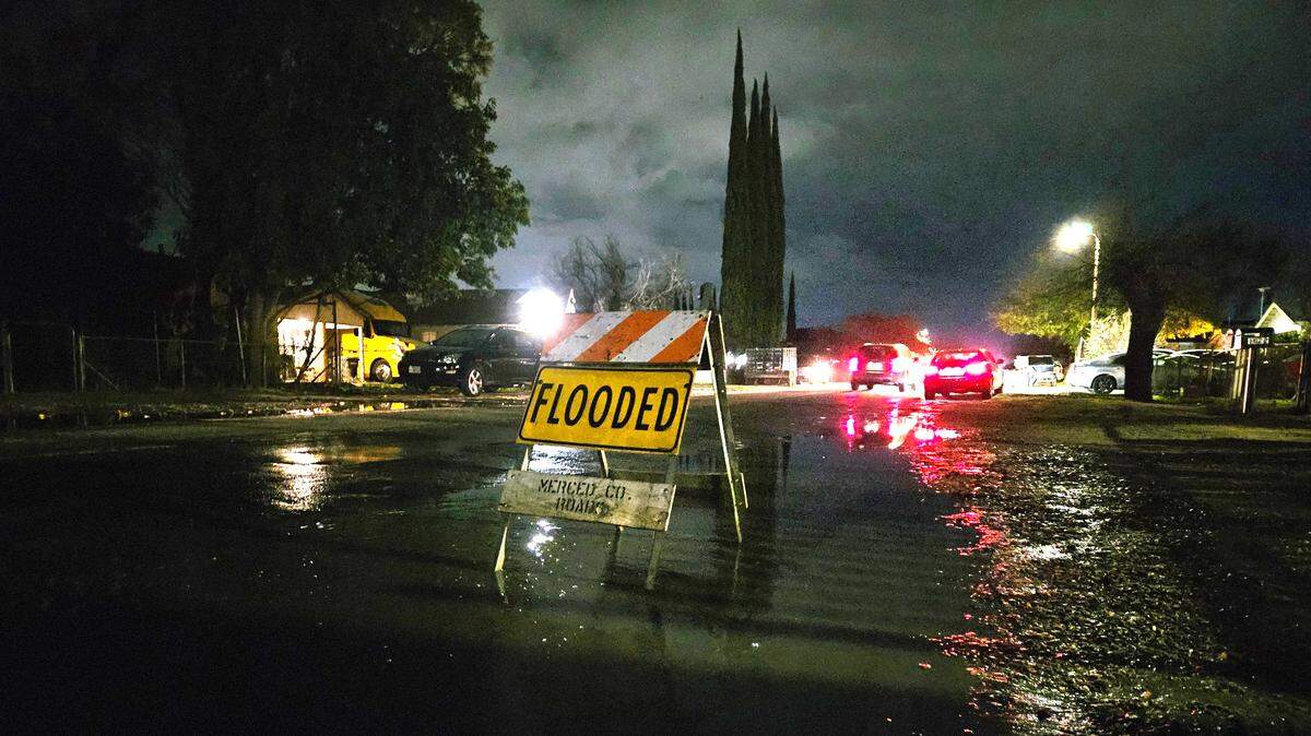A flooded sign on a large puddle on a street in south Modesto, Dec. 29, 2023.
