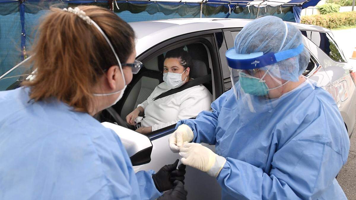 Bee employee Maria Figueroa, middle, talks with community health educator Antonia Kinslow, let, and registered nurse Nancy Norton after being tested for COVID-19 in Salida, Calif., on Wednesday, April 29, 2020. Figueroa is the research and information specialist at The Modesto Bee.