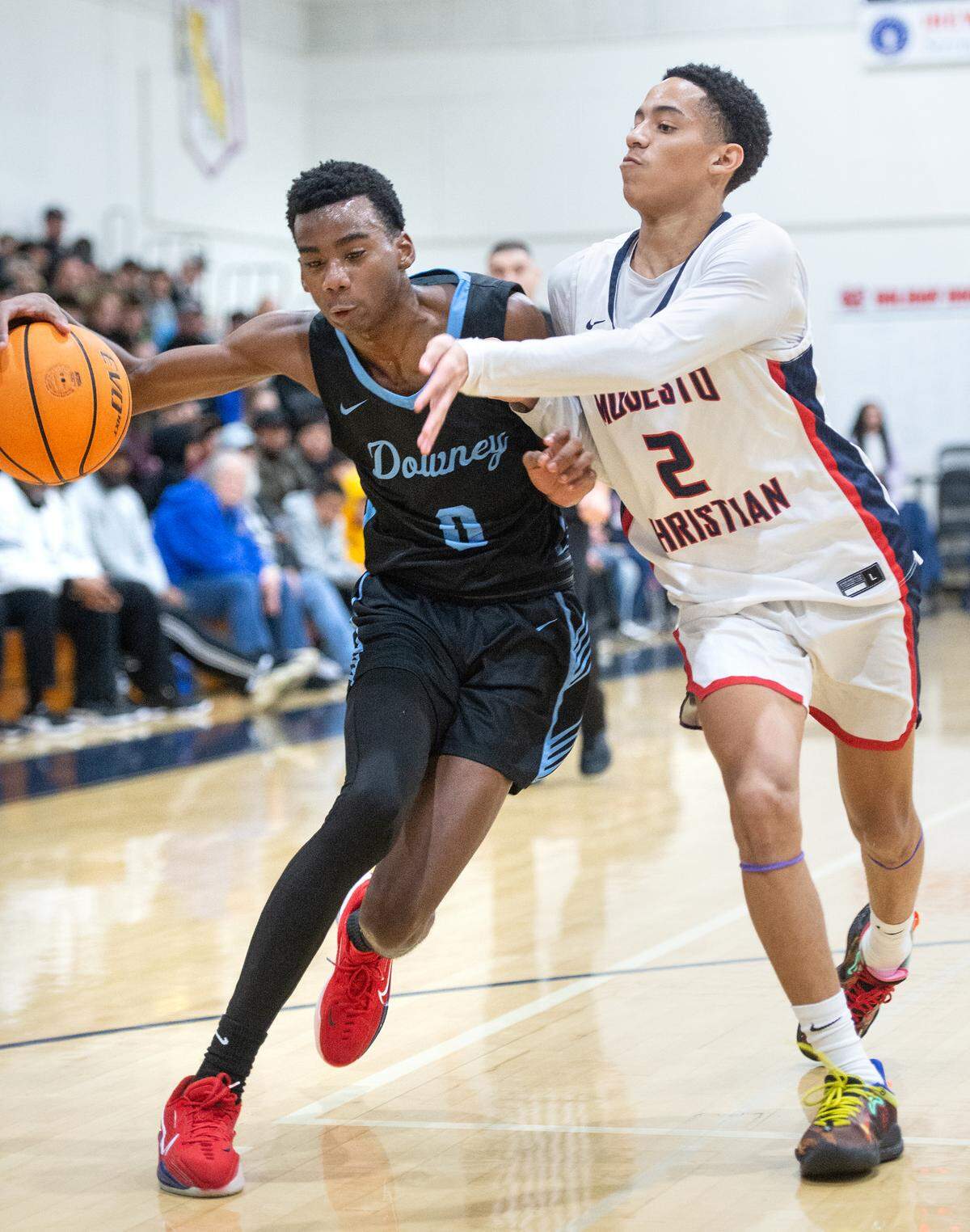 Modesto Christian’s Rashod Cotton, right, defends on Downey’s Reuben Lewis during the Modesto Christian Holiday Hoop Classic in Salida, Calif., Tuesday, Dec. 27, 2022.