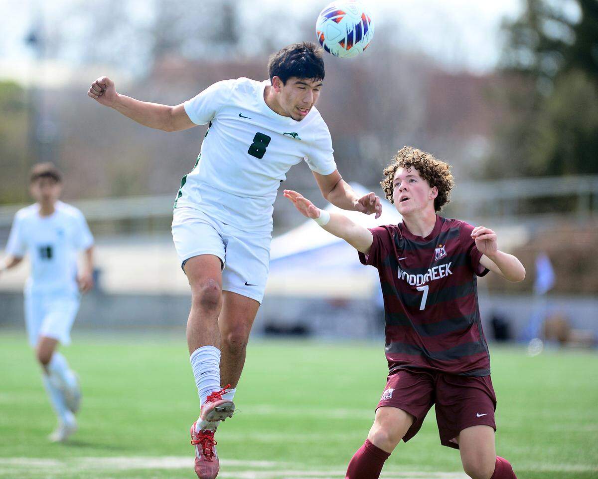 Pitman’s Davian Lizarraga (8) jumps to head a ball over Woodcreek’s Davin Bloom (7) during the Sac-Joaquin Section Division II championship against Woodcreek High School at Cosumnes River College in Sacramento, Calif. on Saturday, March 1, 2025.