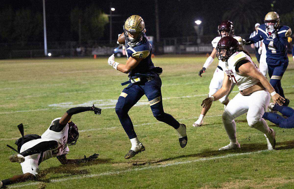 Central Catholic’s Brooklyn Cheek evades Edison defenders during the Sac-Joaquin Section Division I quarterfinal game at Central Catholic High School in Modesto, Calif., Friday, Nov. 10, 2023.