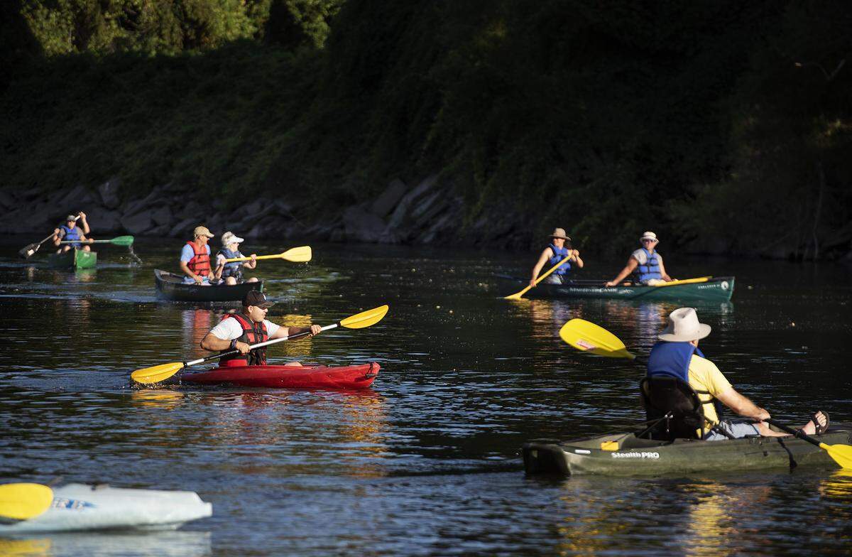Boaters navigate the waters of the Tuolumne River at Legion Park in Modesto, Calif., Thursday, August 1, 2019.