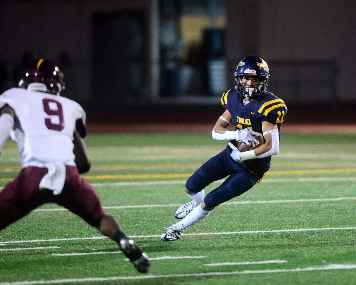 Turlock receiver Jeremiah Bertalotto (11) cuts upfield during a CIF Division I CIF Sac-Joaquin Section Football Playoff game between Turlock High School and Edison High School at Turlock High School in Turlock CA on November 4, 2022. Turlock won 35-0.