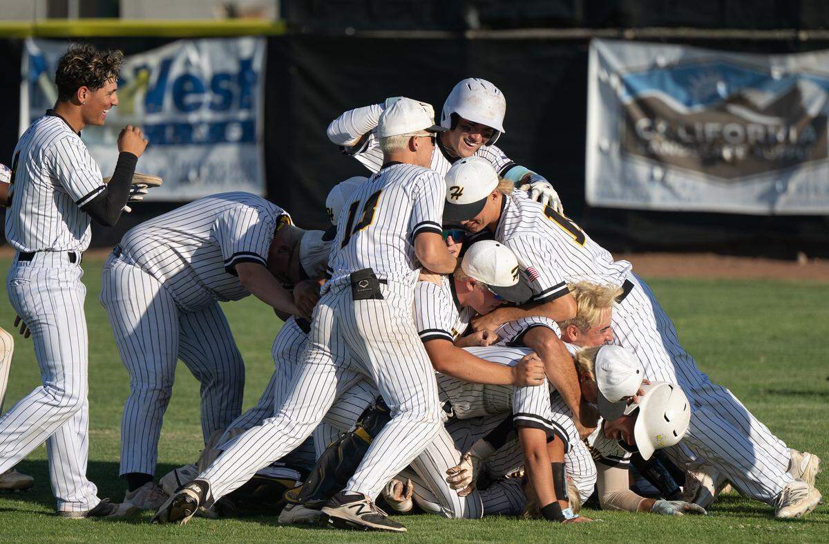 Hughson players celebrate their Sac-Joaquin Section Division V semifinal series victory over Wheatland at Hughson High School in Hughson, Thursday, May 15, 2025. Hughson will play Lincoln High for the section title.