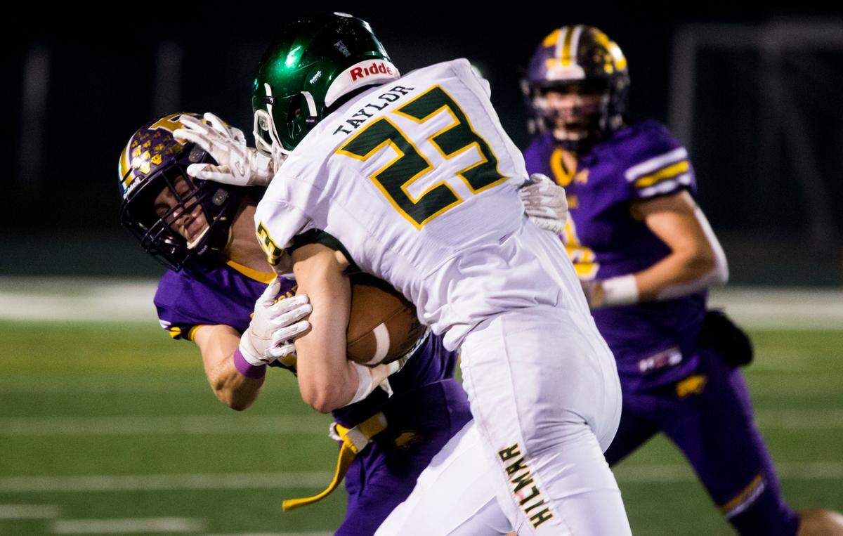 Hilmar Highs Derek Taylor, 23 pushes Escalon Highs Owen Nash, 13, away as he makes his way up field. Escalon High School took on Hilmar High football during the 2021 CIF Sac-Joaquin Football Playoffs - Division V at Saint Mary’s High School in Stockton, Ca. Escalon came out on top as the champions with a 20-13 win over Hilmar.