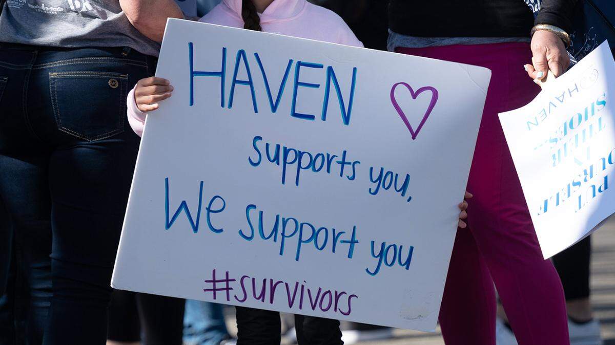 Jinez Rodriguez, 8, holds a sign before the In Their Shoes fundraising walk for HAVEN in Modesto in 2023. HAVEN stands for Healthy Alternatives to Violent Environments and it provides support services for victims of domestic violence, sexual assault and human trafficking. California Democrats are now disagreeing on how to prosecute some teen prostitution solicitations.