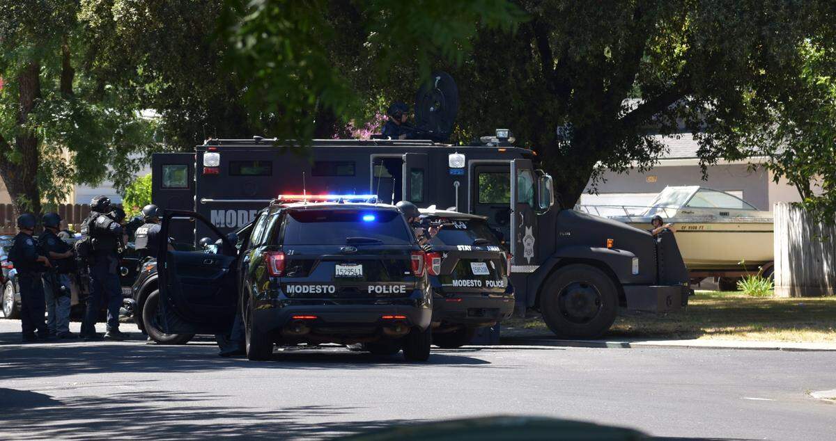Police officers and sheriff’s deputies were in a standoff with a homicide suspect following a fatal shooting on Debbie Lane in central Modesto on Sunday afternoon, July 10, 2022.