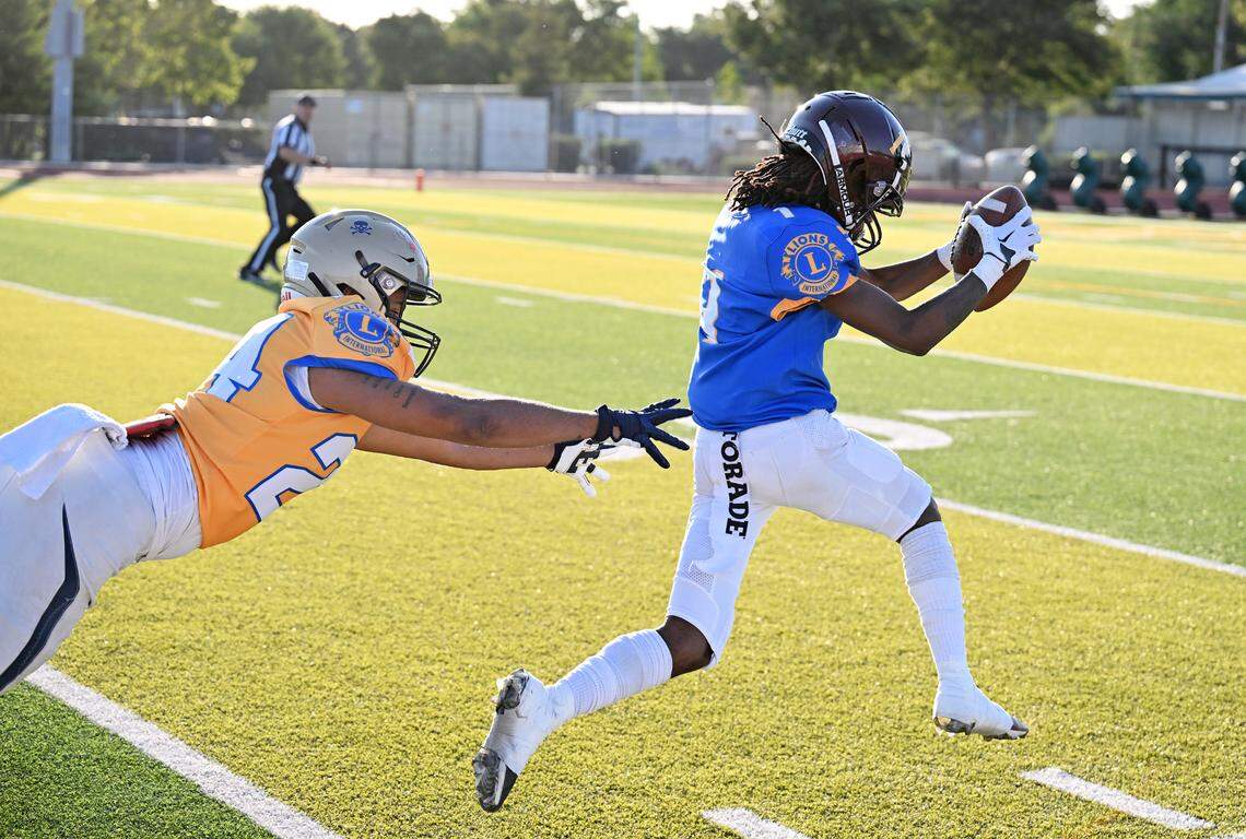 North receiver Tyree Owens (Edison) skips away from South defender Roland Brown (Central Catholic) on a catch and run for a touchdown during the Central California Lions All-Star Football Game returns at Tracy High School in Tracy, Calif., Saturday, June 24, 2023.