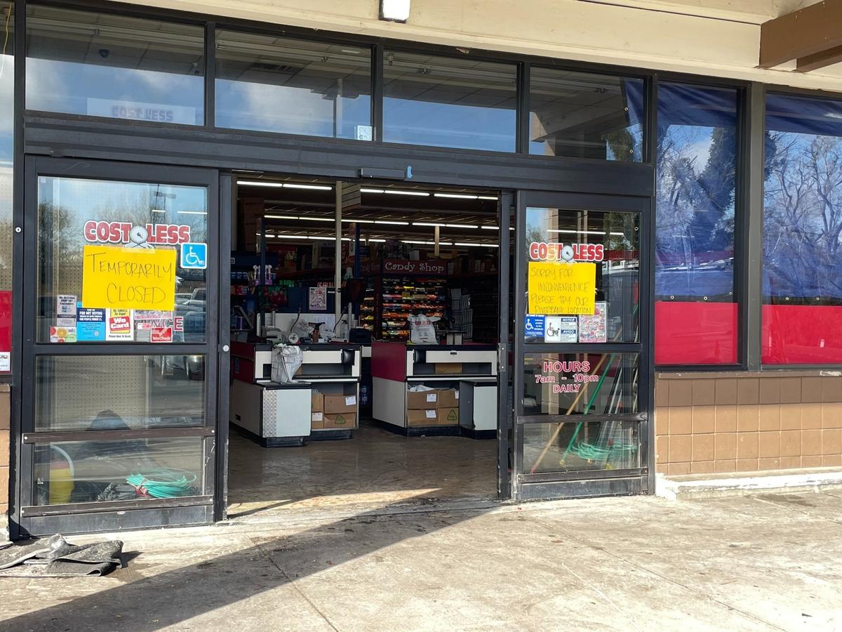 Entrance to Cost Less Food Company with temporary closure signs on the doors after a part of the roof collapsed during heavy rainfall on Monday, March 17.