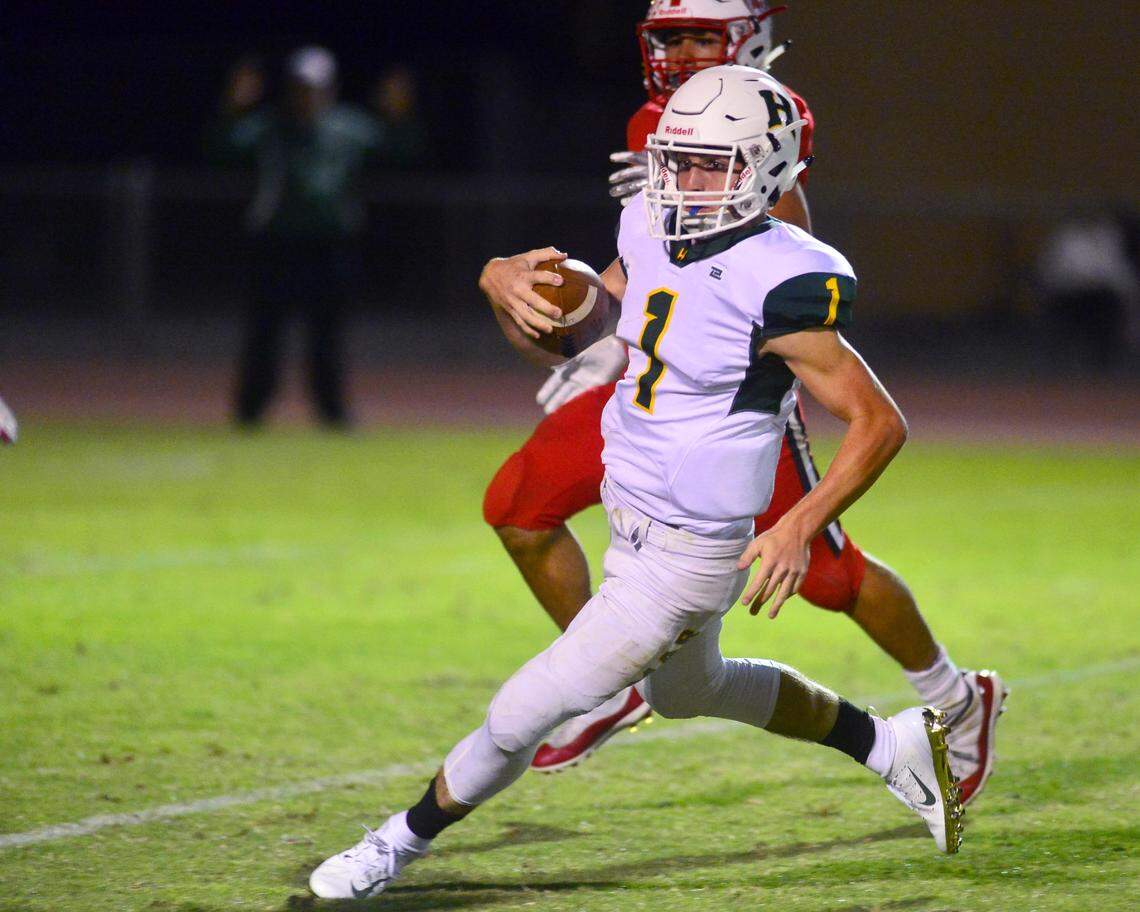 Hilmar quarterback Ryan Texieira (1) cuts upfield on a scramble during a game between Ripon and Hilmar at Ripon High School in Ripon CA on September 14, 2018.
