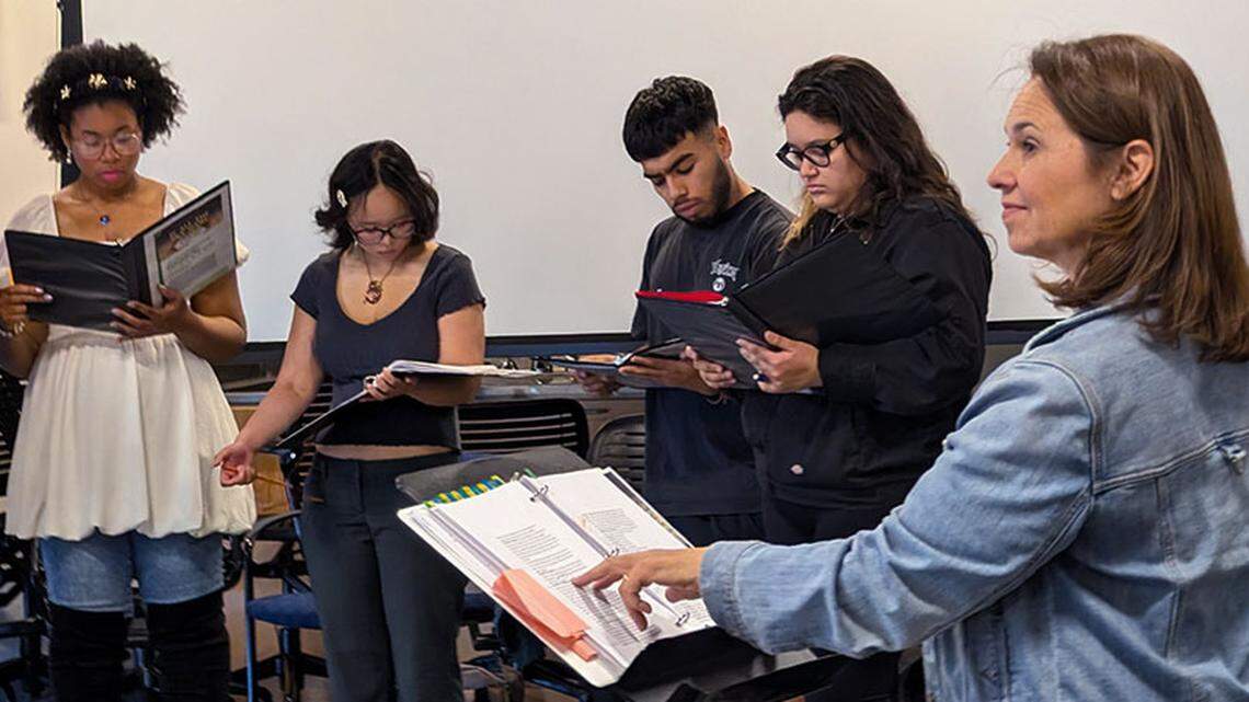 Students gather with their director, continuing lecturer Jenni Samuelson (right), for a rehearsal of ‘If All the Sky Were Paper.’