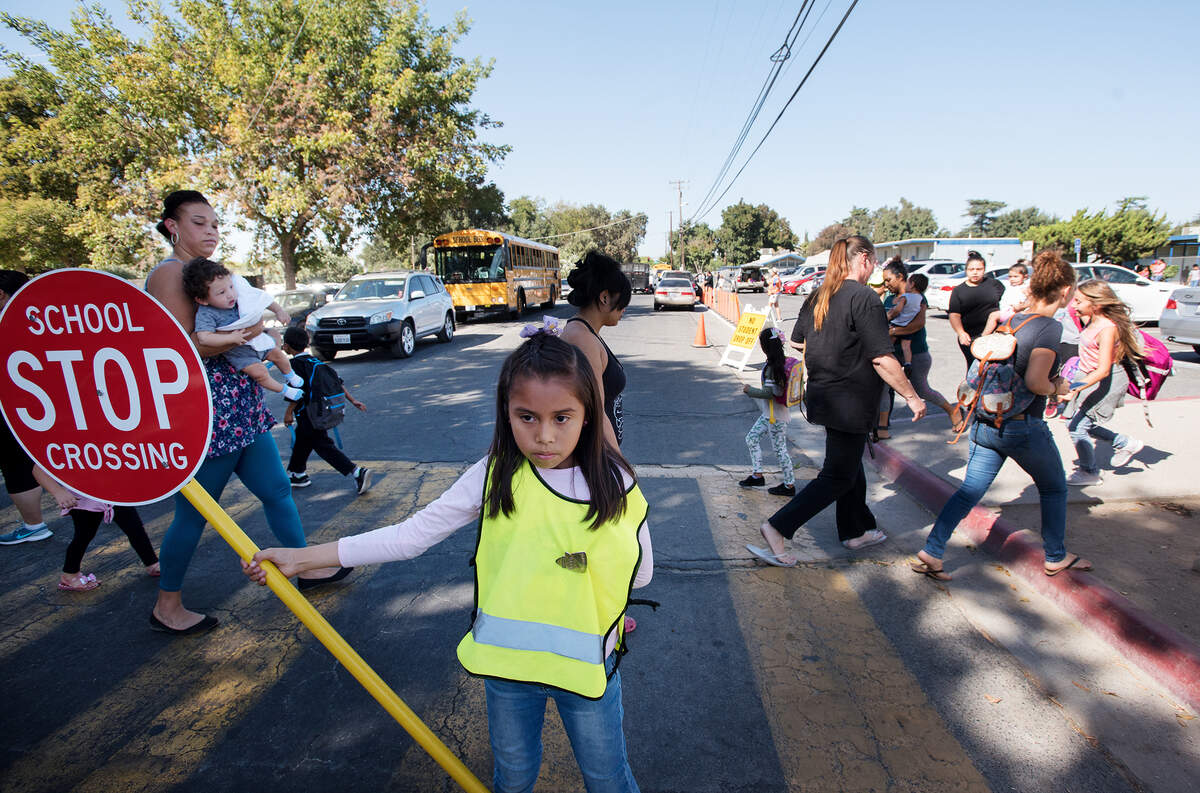 Voters approved Measures D and E in 2018 for school bonds in Modesto City Schools, hoping for upgrades such as better vehicle access. Pictured is Maria Castaneda working safety patrol at Franklin Elementary School in Modesto, Calif., in September 2018.