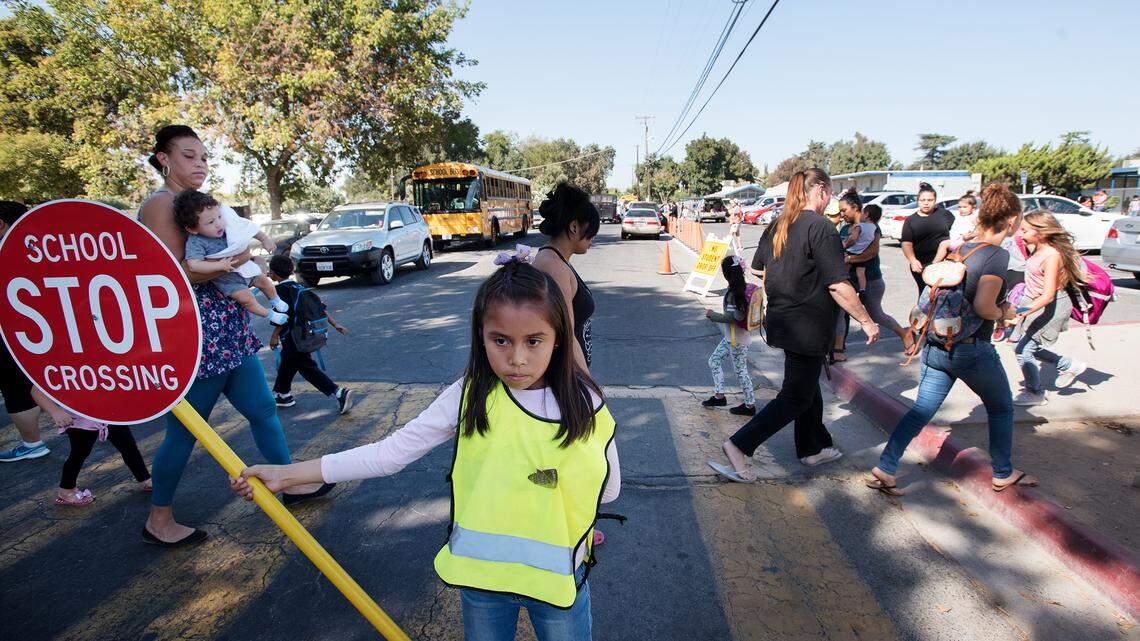 Fifth-grader Maria Castaneda works on safety patrol as school lets out at Franklin Elementary School in Modesto, Calif., on Tuesday, Sept. 25, 2018. Modesto City Schools has two bond measures on the November ballot to generate funds for renovating elementary school facilities. District officials want to improve the access for cars and pedestrians outside the school for better safety and traffic flow.