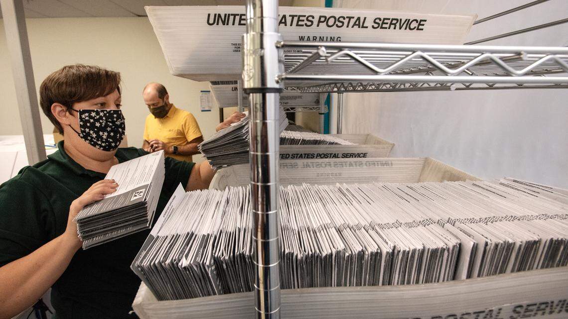Registrar of Voters staff member Kyndria prepares ballots for sorting in Modesto, Calif., on Friday, Oct. 16, 2020.