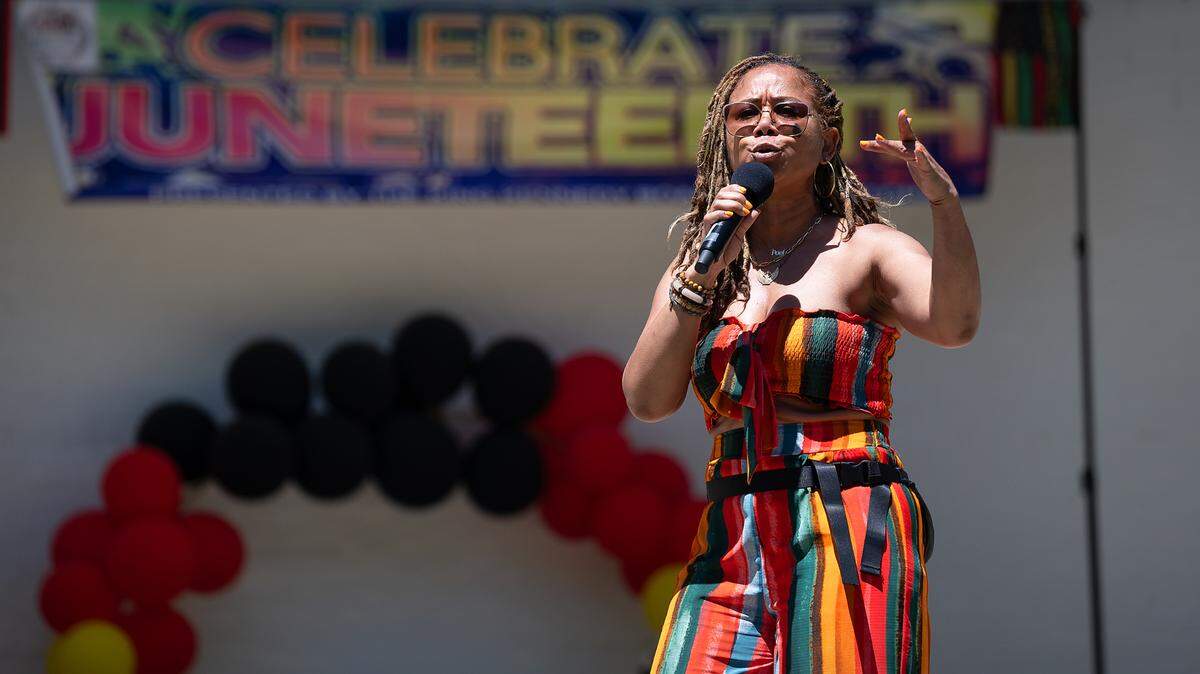 Angela Drew performs a spoken word poem during the Juneteenth celebration at Graceada Park in Modesto, Calif., Saturday, June 15, 2024.