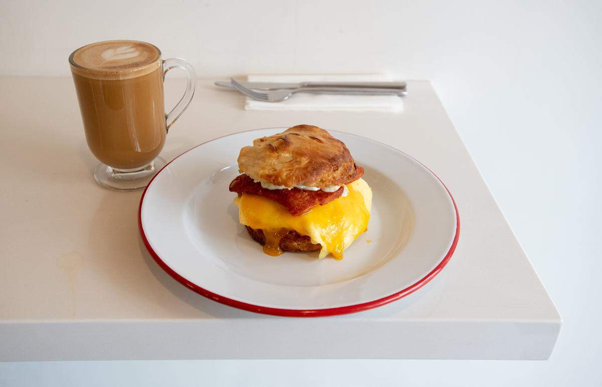 South x Southwest (scrambled egg, linguica, green chile aioli, sharp cheddar cheese, on house made buttermilk biscuit) and cafe Americano at Lucille cafe in Modesto, Calif., Friday, Feb. 3, 2023.