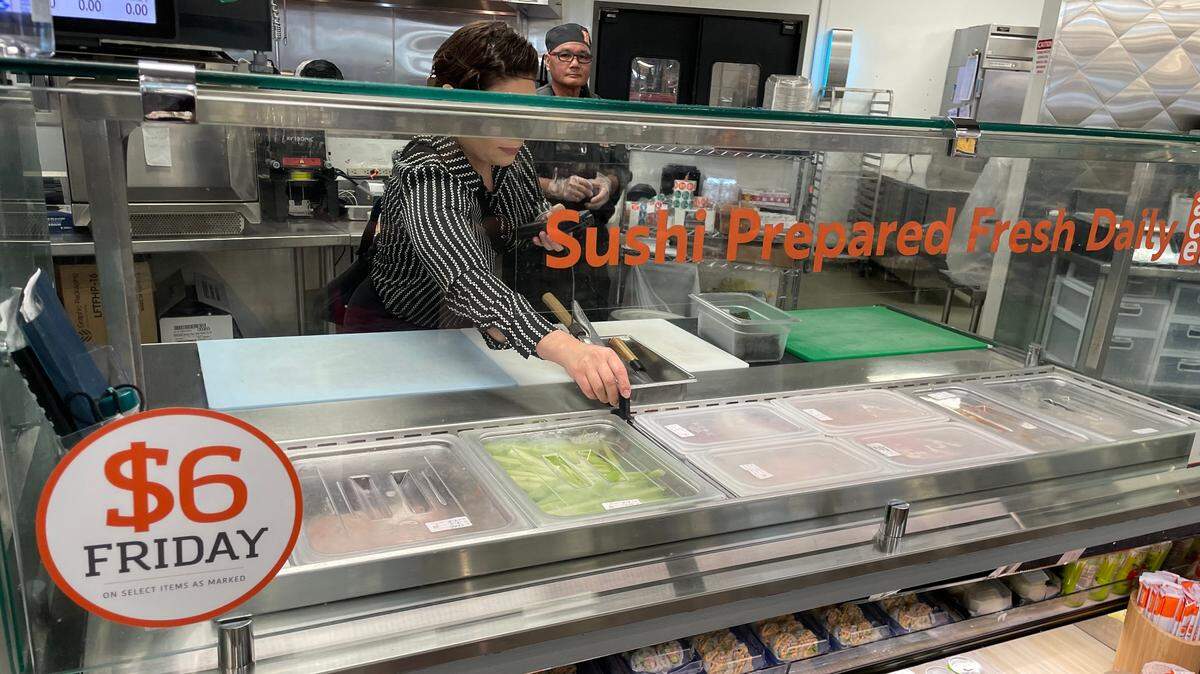 Registered Environmental Health Specialist Alondra Estrada checks the temperatures of cold food prep trays used for making sushi during a routine health inspection inside Save Mart on Sept. 5, 2024.
